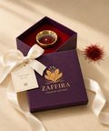 Zaffira Gift Box with satin ribbon and gift tag, open to show the gold saffron capsule